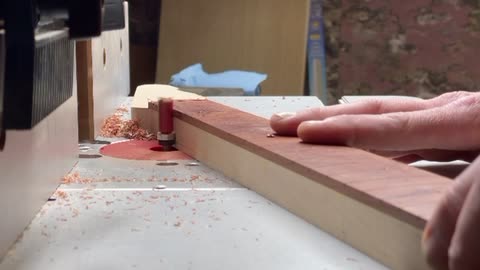 Flush trimming the fretboard.