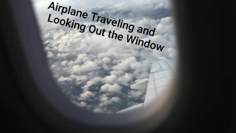 Airplane Traveling and Looking Out the Window