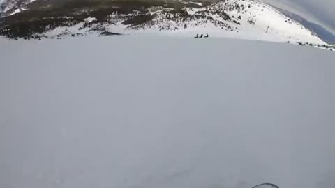 First person man tumbles in snow after skiing