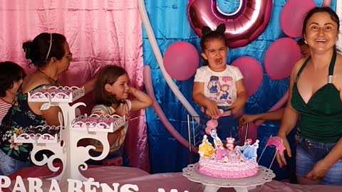 Sisters Fighting to Blow Out the Birthday Candle