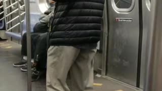 Old man hat plays wooden flute on subway