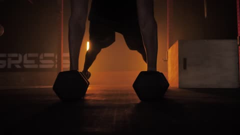 Man doing push ups using dumbbells