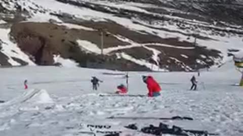 Guy blue jacket red pants ski backflip fail