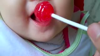 Baby eating candy is cute and funny