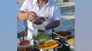 Acarajé (a type of sandwich made with bean dough) in the streets of Salvador, Bahia, Brazil