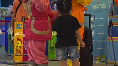 Baby dancing with funny stuffed puppets.