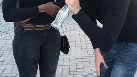 The magician broke the bottle, and the people next to him were dumbfounded