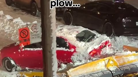 Snowplow gives a gentle push to a car stuck in a snow in Montreal