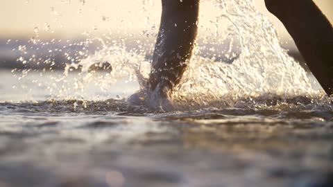 Walking Through Surf and Kicking Up Spray