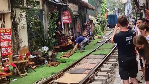 Couple Visit Hanoi's Famous Train Street