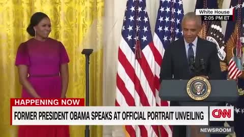Barack Obama gives a speech after the unveiling of his White House portrait
