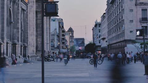Street with people walking at dusk