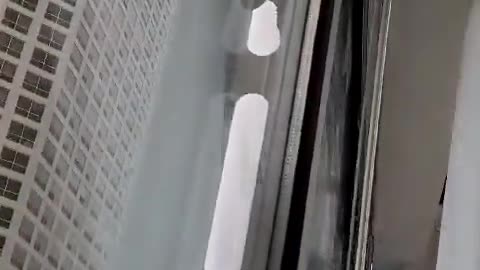 "A man is free-climbing the Accenture Building in Downtown Chicago