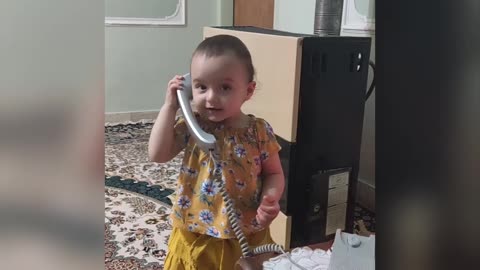 The child is surprised by the sound of the phone