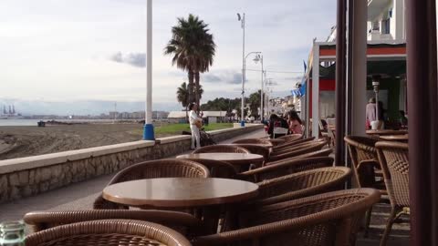 Relaxing in a seaside cafe outside with Street buskers