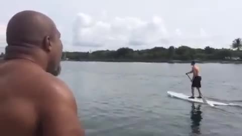 Wladimir Klitschko gets knocked off his paddleboard in FLA