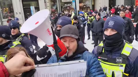 Reading the Canadian Bill of Rights infront of the police line blocking Sparks street in Ottawa.