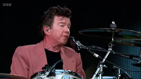 Rick Astley on drum duty covering AC/DC in Glastonbury.