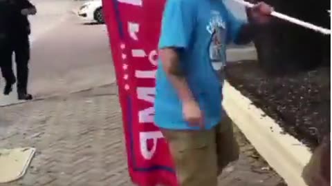 Hater spits on Trump flag, speeds off and then crashes into a pole.
