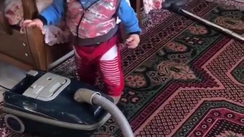 Little boy helps mom with the vacuuming! Love this! Funny!