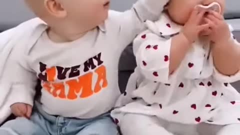 Cute baby playing with sister