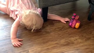 Toddler Has a Hard Time Reaching for Toy