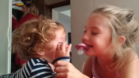 Cute Baby and Siblings Playing with Pacifier