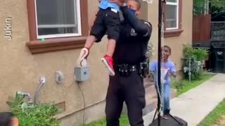 Police Officer Lifts Little Kids to Help Them Dunk Basketballs