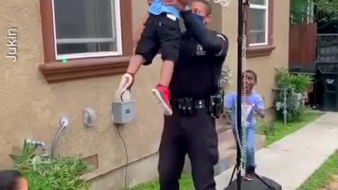 Police Officer Lifts Little Kids to Help Them Dunk Basketballs