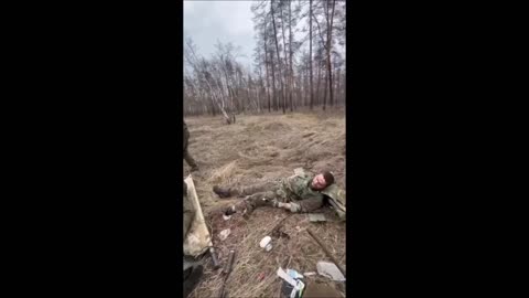 Russian soldiers moving through brush step on pedal mines and receive first aid