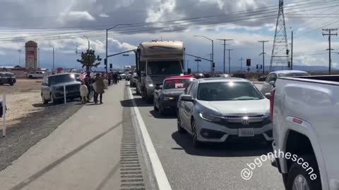 Freedom Convoy USA - Canadian and American flags out as supporters of the trucker convoy gather on the side of the highway here in California