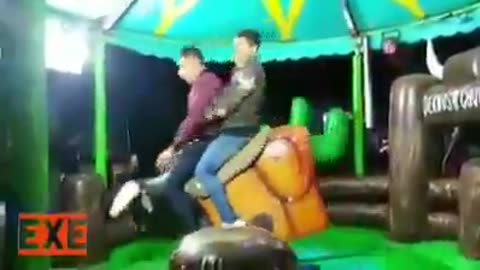 Two young men riding a bull - really funny! :-)