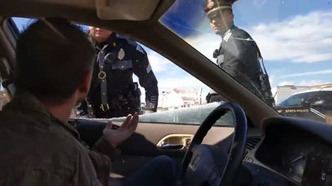 NM State Police officer breaks out driver's window