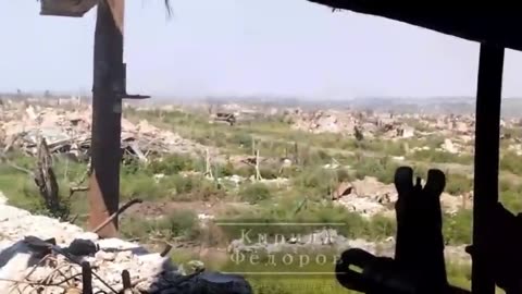 Russian tank moves through the ruins of Maryinka