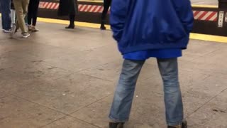 Blue jacket man dances in subway