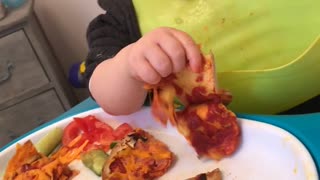 Sleepy Baby Enjoys Pizza