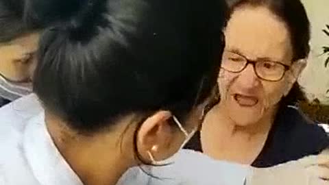 Nurses forcibly "vaccinating" a lady