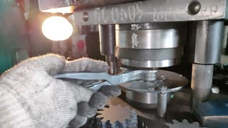 punching a hole in a metal sprocket