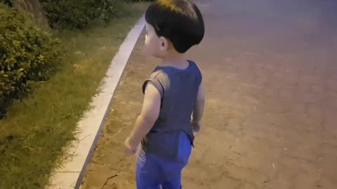 A child having difficulty catching soap bubbles