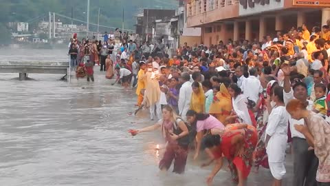 Tourist falls into river during religious ceremony in India