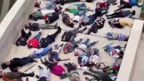 Hundreds of protesters lay down outside Guggenheim Museum Bilbao to mimic Gaza