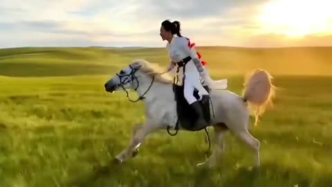 Beautiful woman riding a horse in the grassland