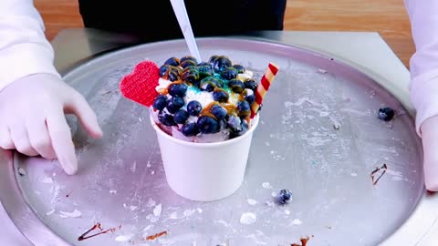 Blueberry ice cream rolls street food