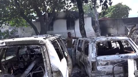 Charred cars left after gang attack in Haiti