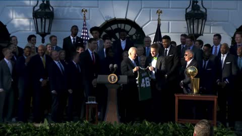 Biden is presented with a Milwaukee Bucks jersey