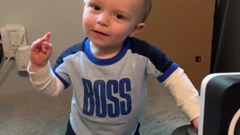 Toddler cracks himself up.