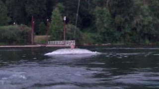 Wakeboard guy gets pulled and stands up then instantly falls forward into water