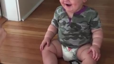 Baby laughing hysterically at mom's sunglass trick