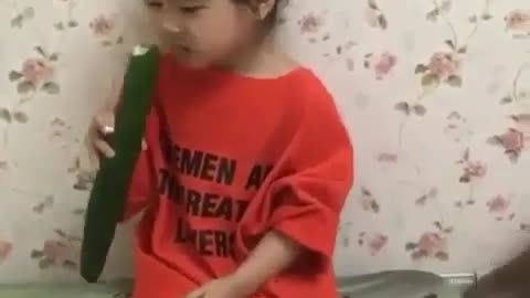 A girl with cucumber and her funny monkey