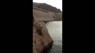 Two guys cliff dive faceplant